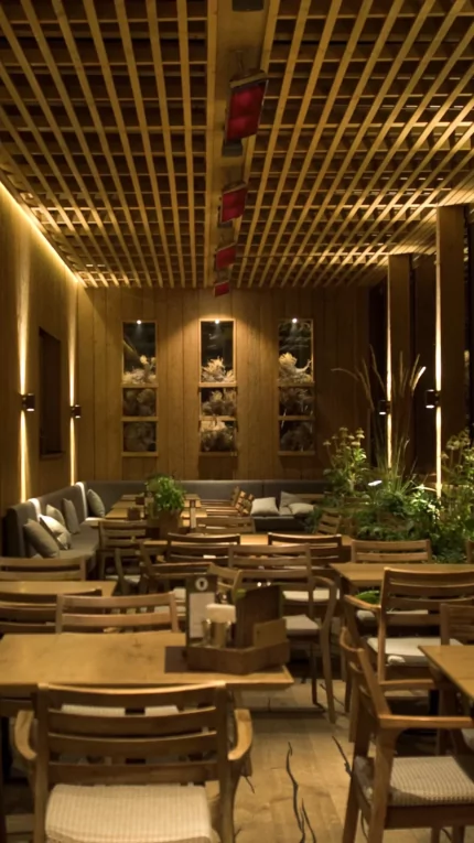 Heatscope Vision 3200W Radiant Heater, matte-black, ceiling-mounted above open-air restaurant tables, delivers silent infrared electric patio warmth.