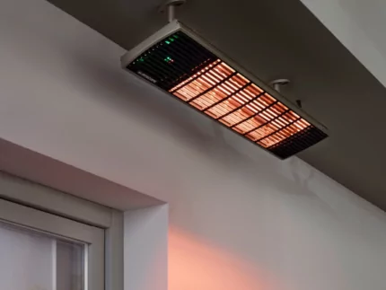 Heatscope Heaters Spot 2800W Radiant Heater wall-mounted on a restaurant terrace, outdoor electric infrared heating in Commercial Space.