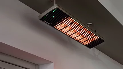 Heatscope Heaters Spot 2800W Radiant Heater wall-mounted on a restaurant terrace, outdoor electric infrared heating in Commercial Space.